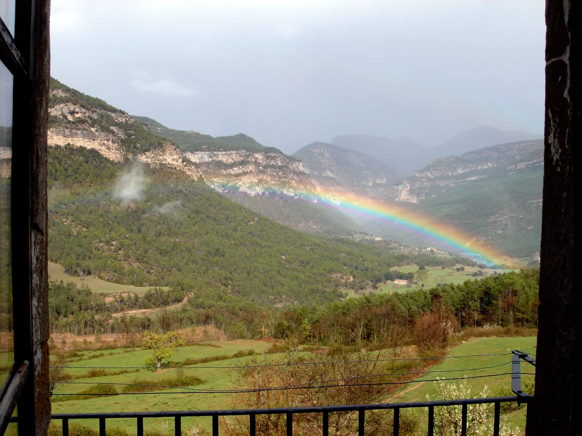Rainbow seen from a farmhouse window