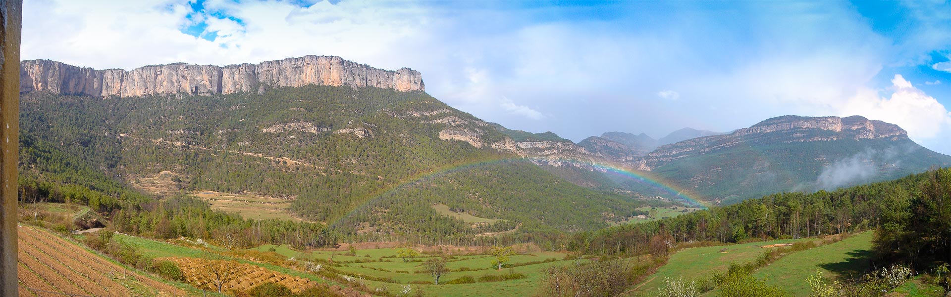 Busa cliffs and the Vall d’Ora with a rainbow
